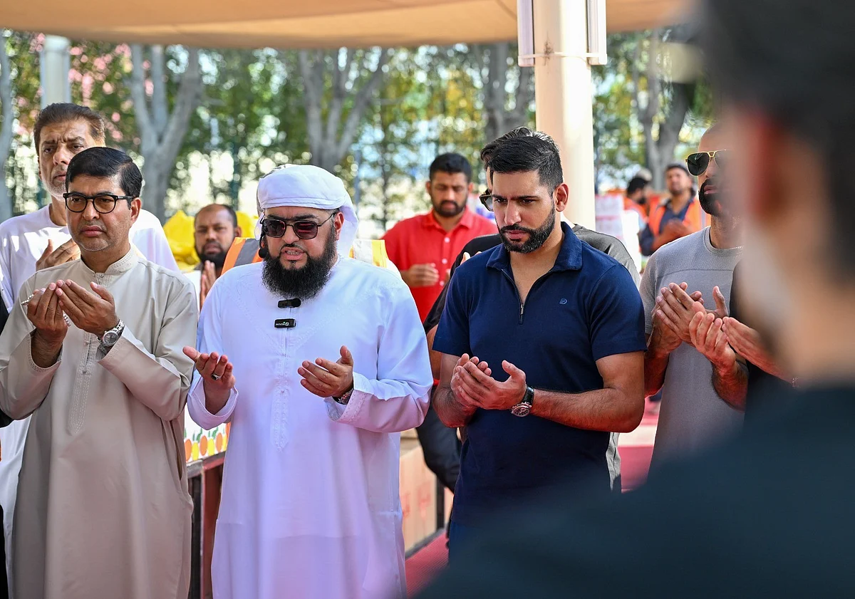 Mohammed Karim (centre), British former professional boxer Amir Khan (right)
