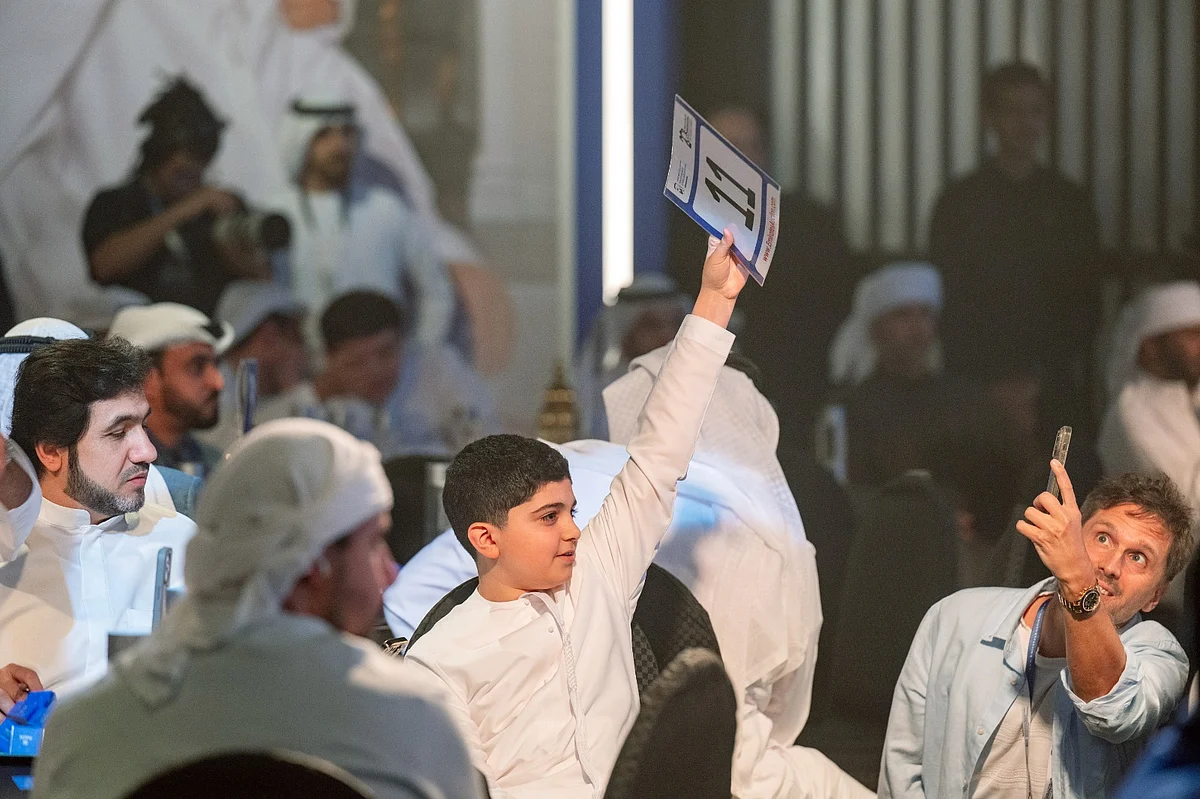 13-year-old boy bids during the auction. Photo: Shihab
