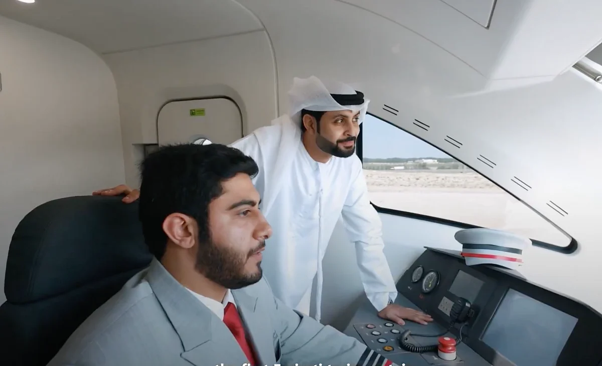 Captain Ibrahim Al Hammadi, the first Emirati train captain for Etihad Rail (seated)