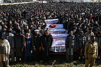 Look: Thousands gather as Pakistan buries victims of mosque suicide attack