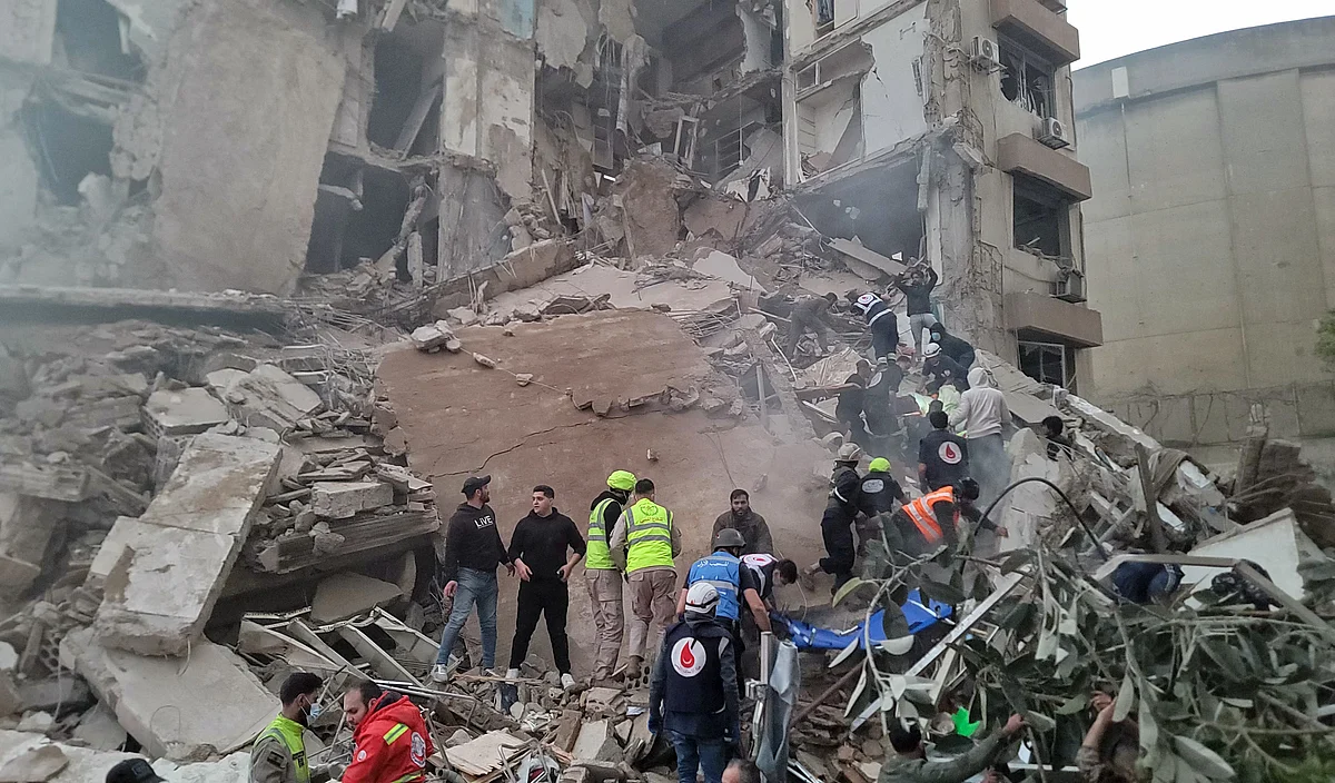 First responders and residents gather at the site of an Israeli airstrike in Beirut's Tallet al-Khayyat neighbourhood, on April 8, 2026.