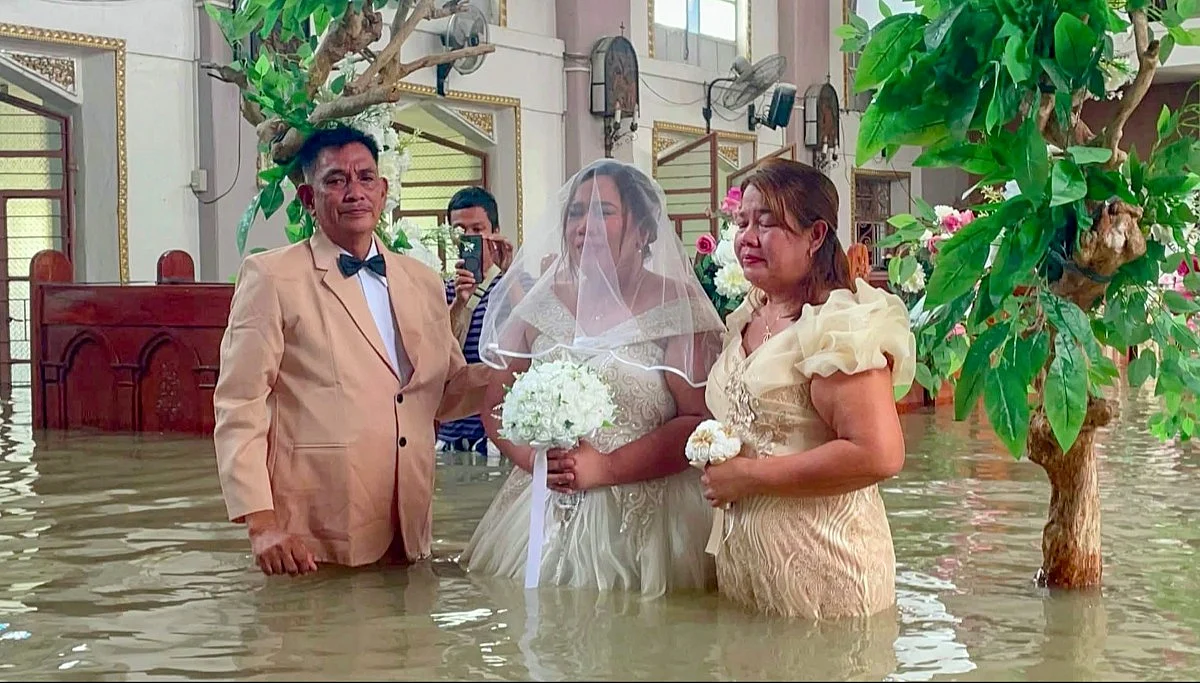 'Nothing could stop union': Philippine couple ties the knot in hip-deep floodwaters