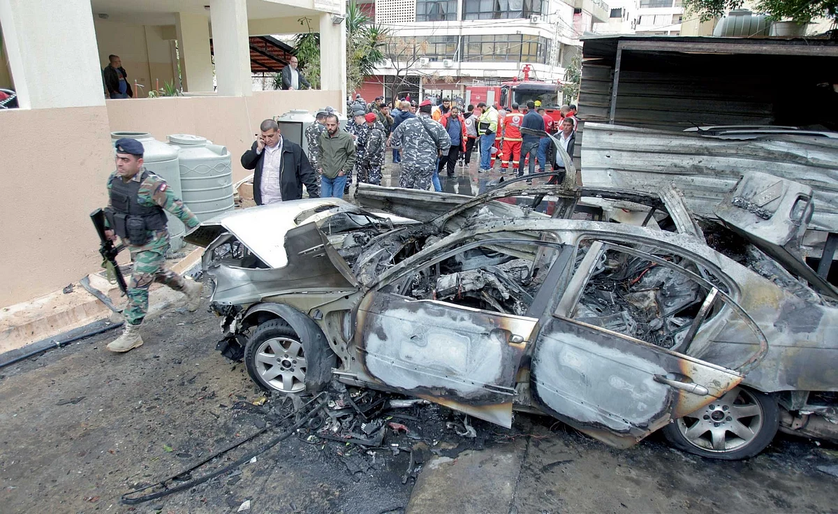 Lebanese soldiers inspect the damaged car used by Hamas leader Hamdan in Sidon, Lebanon, on Monday. - Reuters