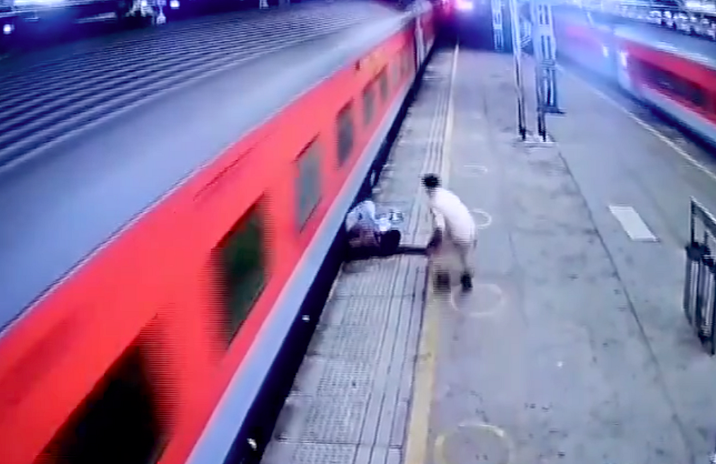Video: Man slips while boarding moving train in India, cop saves life ...